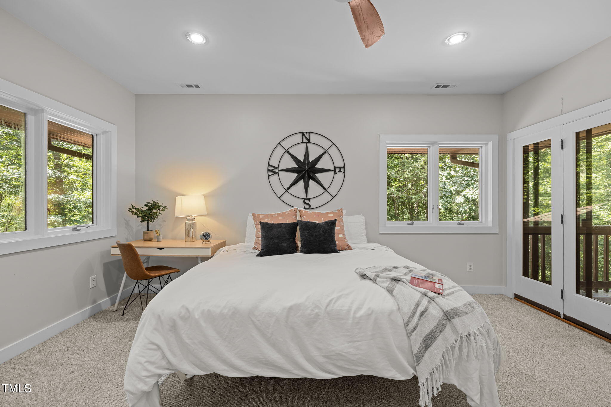 801 Creekstone Drive Chapel Hill, NC 27516 - Photo 18 of 65 a bedroom with a bed and a table with windows