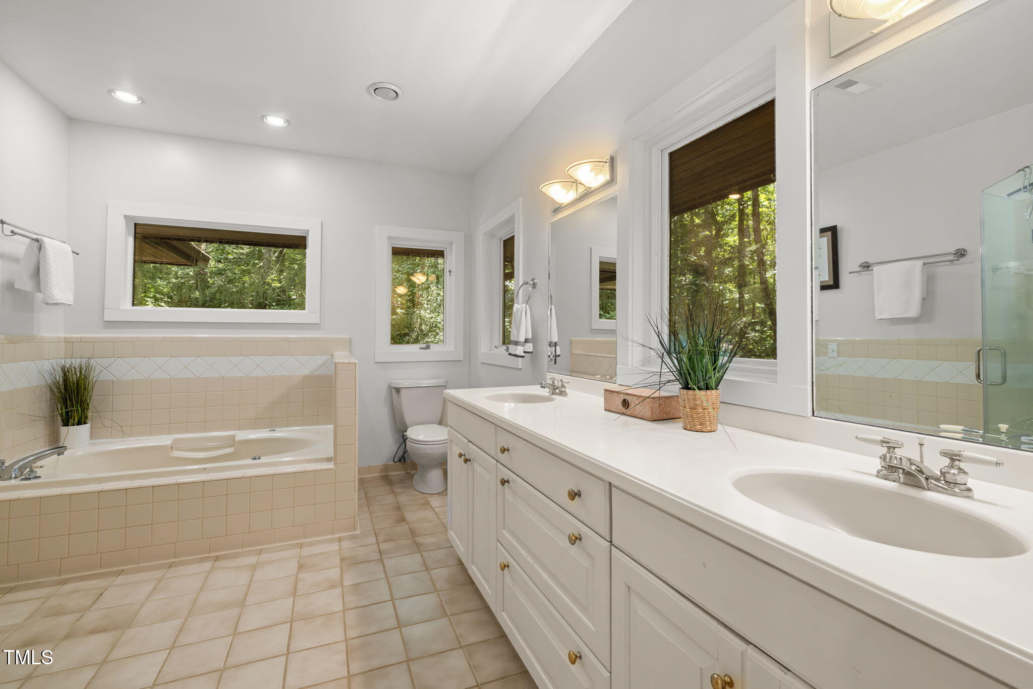 801 Creekstone Drive Chapel Hill, NC 27516 - Photo 19 of 65 a spacious bathroom with a double vanity sink a mirror and a bathtub