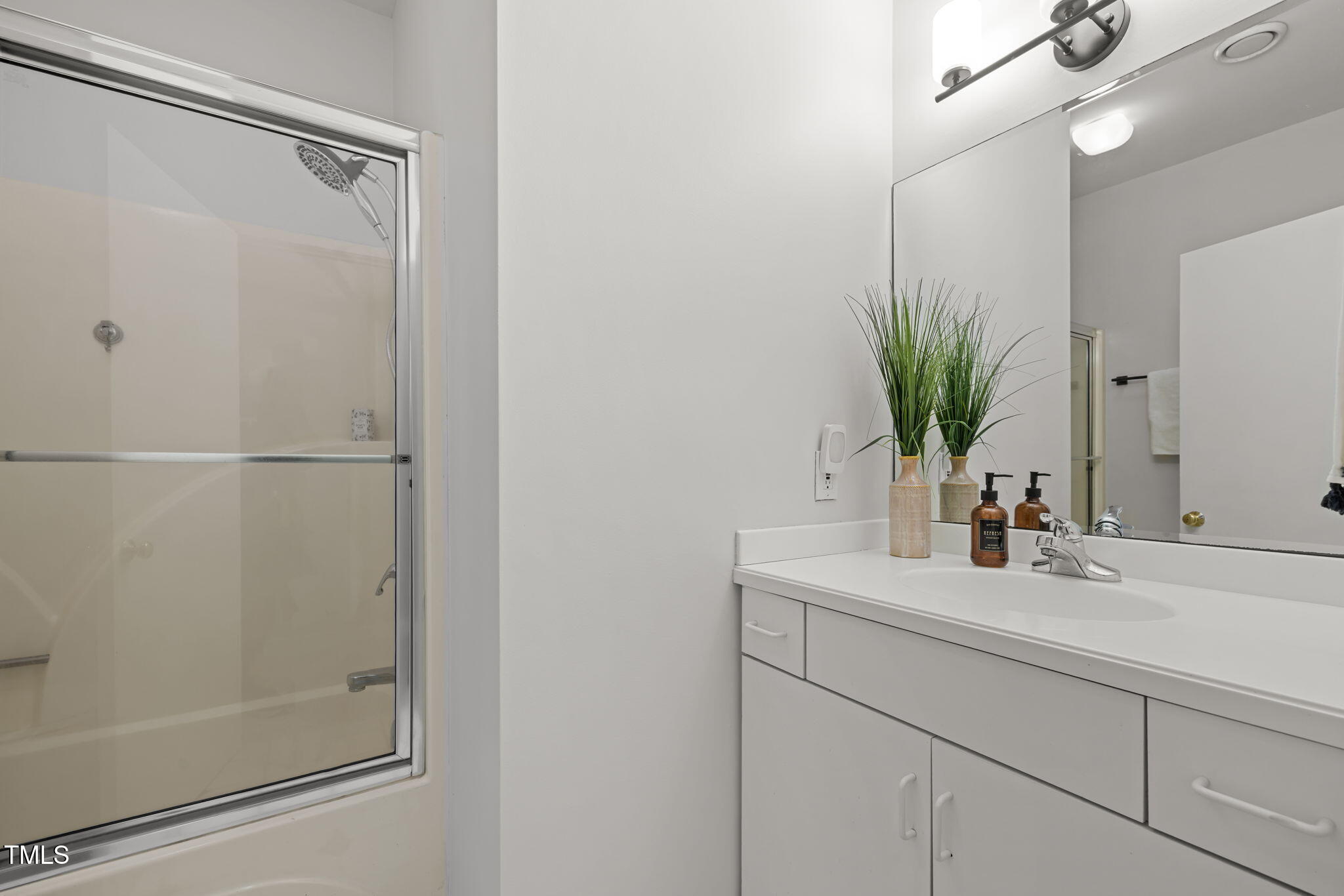 801 Creekstone Drive Chapel Hill, NC 27516 - Photo 29 of 65 a bathroom with a shower sink and mirror
