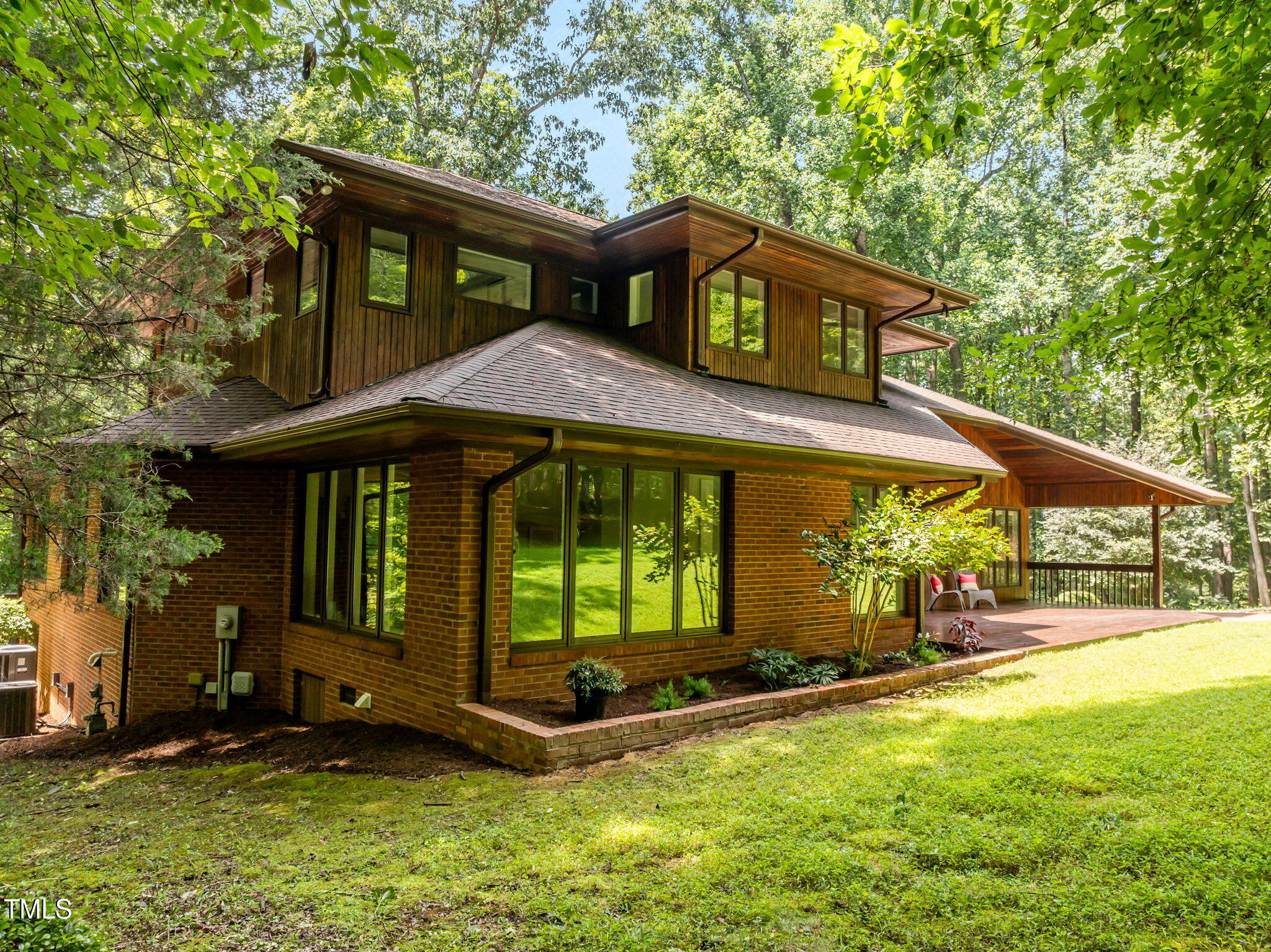 801 Creekstone Drive Chapel Hill, NC 27516 - Photo 35 of 65 a front view of a house with a yard table and chairs
