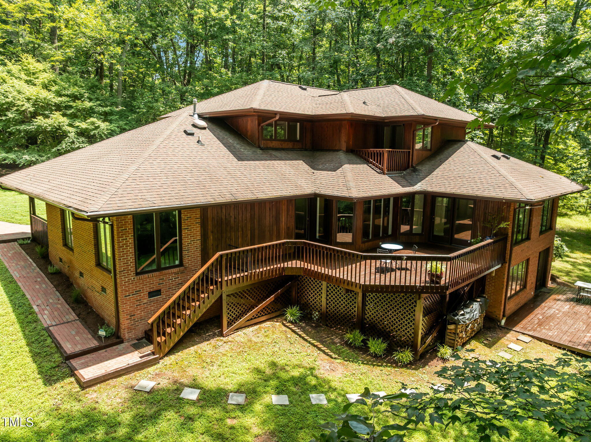 801 Creekstone Drive Chapel Hill, NC 27516 - Photo 61 of 65 a view of a house with roof deck and couches under an umbrella