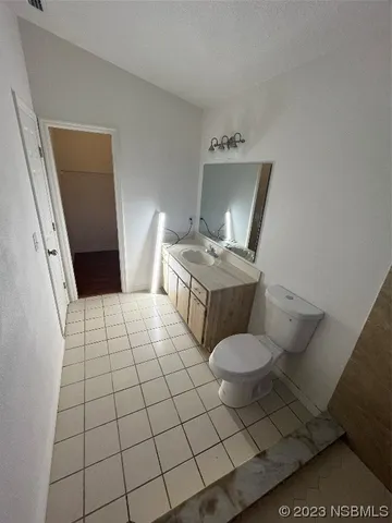 a bathroom with a sink toilet and mirror