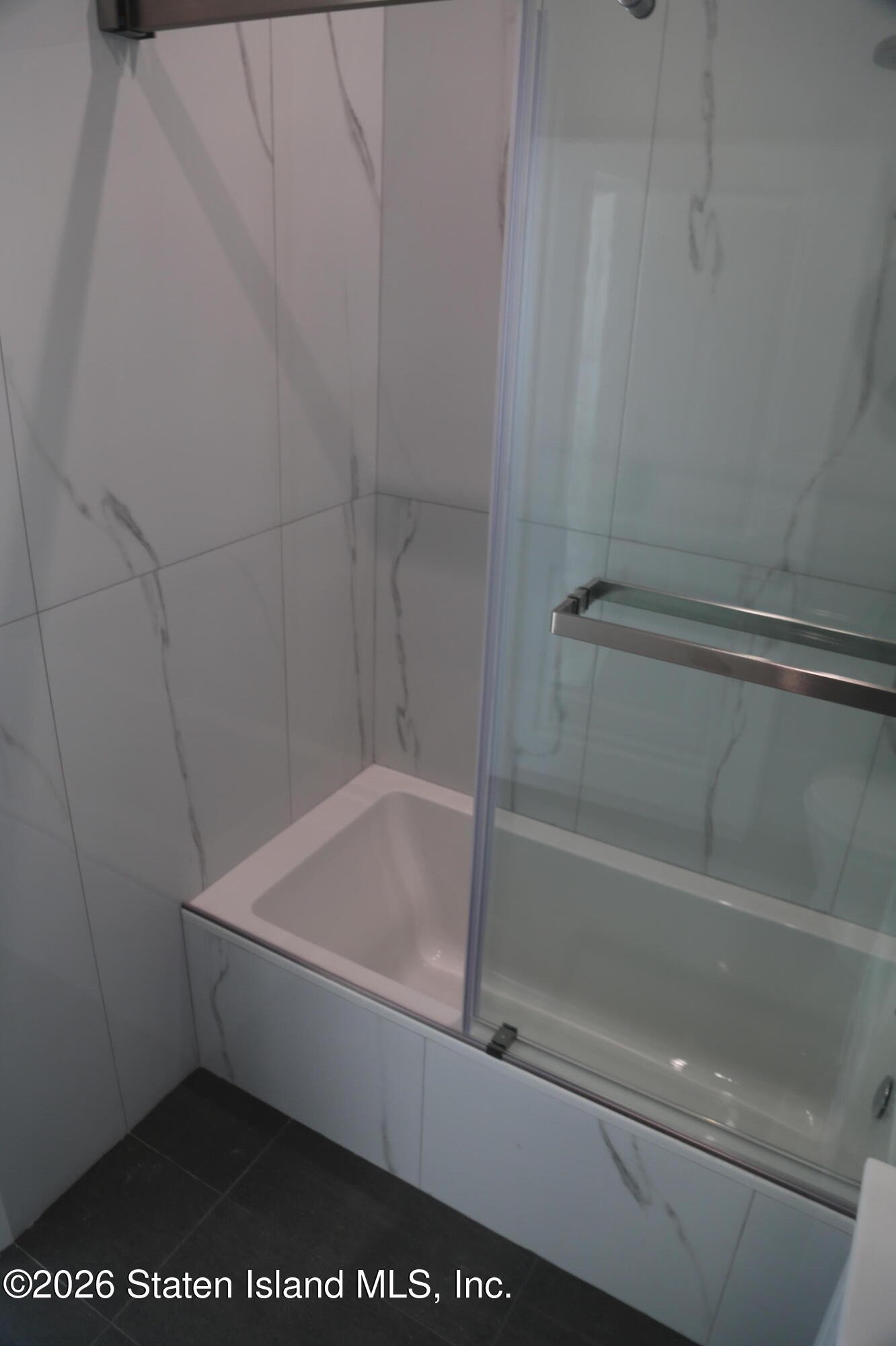 1221 Forest Hill Road, Unit 2 Staten Island, NY 10314 - Photo 9 of 10 a bathroom with a bathtub