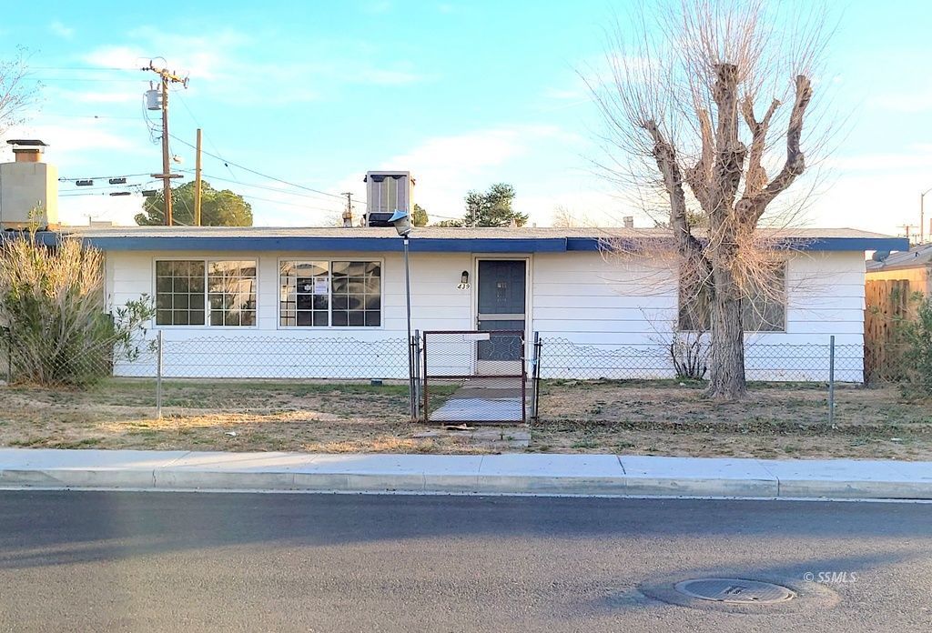 439 West Reeves Avenue Ridgecrest, CA 93555 - Photo 1 of 20 a view of a house with a tree in the background
