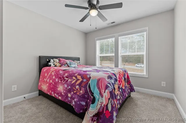a bathroom with a granite countertop sink toilet and mirror