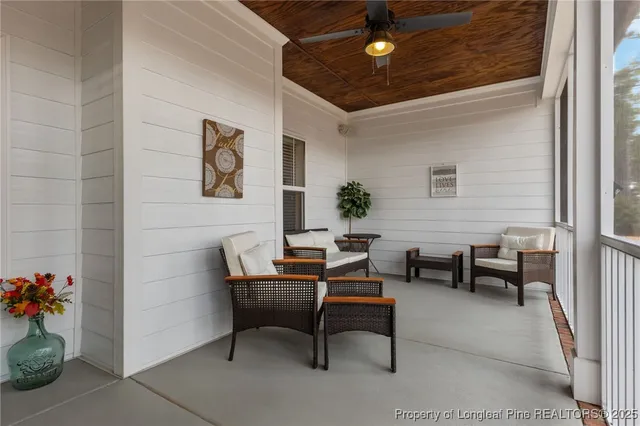 a view of a chairs and tables in the back yard of the house