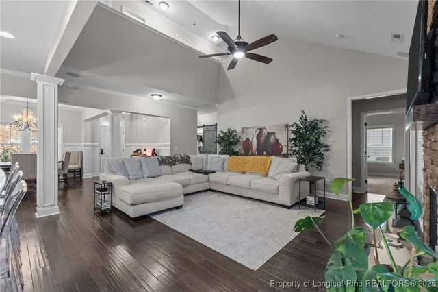 a living room with furniture and a kitchen view