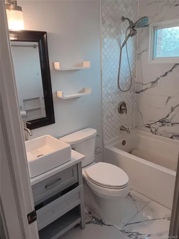 a bathroom with a toilet sink and shower