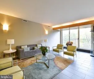 a view of a livingroom with furniture bookshelf and a window