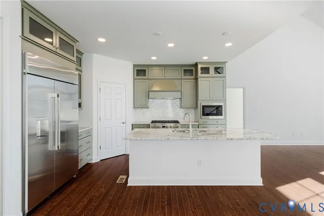 a view of kitchen with stainless steel appliances granite countertop cabinets and wooden floor