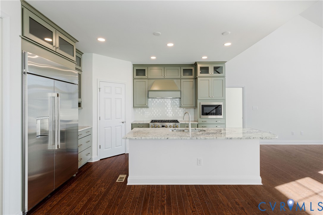 10689 Fern Basket Road Glen Allen, VA 23059 - Photo 12 of 50 a view of kitchen with stainless steel appliances granite countertop cabinets and wooden floor