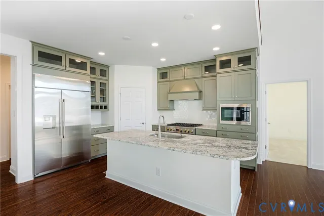 a kitchen with kitchen island a sink appliances and cabinets