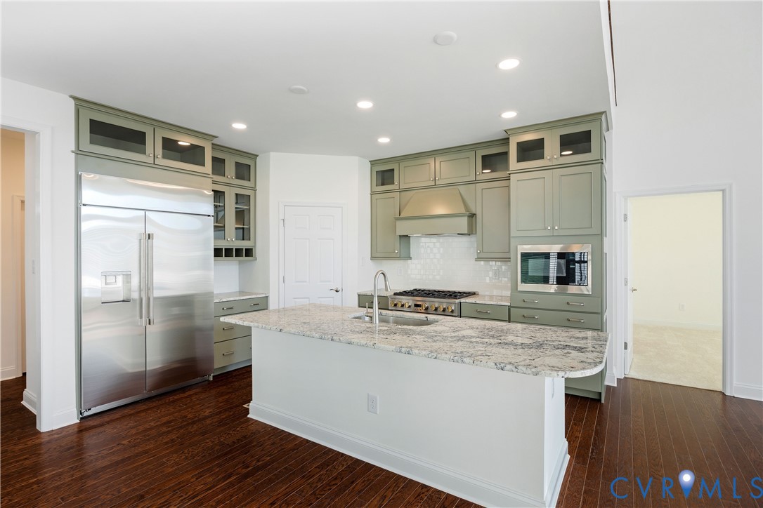10689 Fern Basket Road Glen Allen, VA 23059 - Photo 13 of 50 a kitchen with kitchen island a sink appliances and cabinets