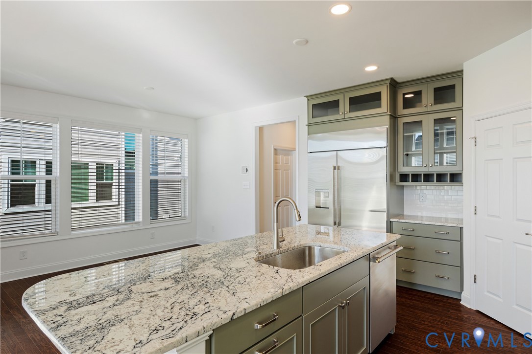 10689 Fern Basket Road Glen Allen, VA 23059 - Photo 15 of 50 a kitchen with a sink stove and cabinets