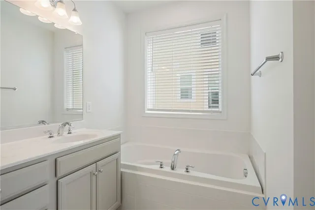 a white bath tub sitting next to a white sink
