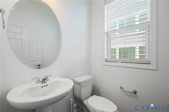 a bathroom with a sink a mirror and a toilet