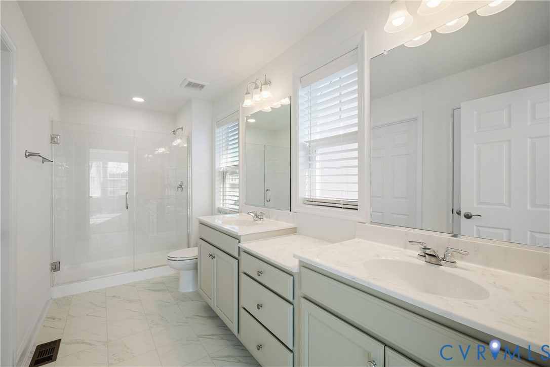 10689 Fern Basket Road Glen Allen, VA 23059 - Photo 38 of 50 a bathroom with a sink double vanity granite tub shower and a mirror