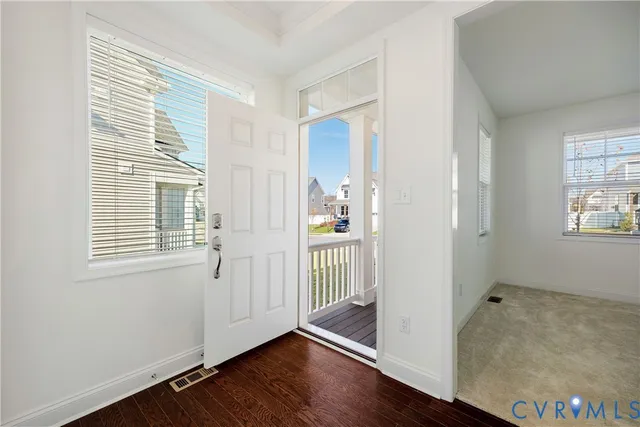 a view of a room with wooden floor and windows