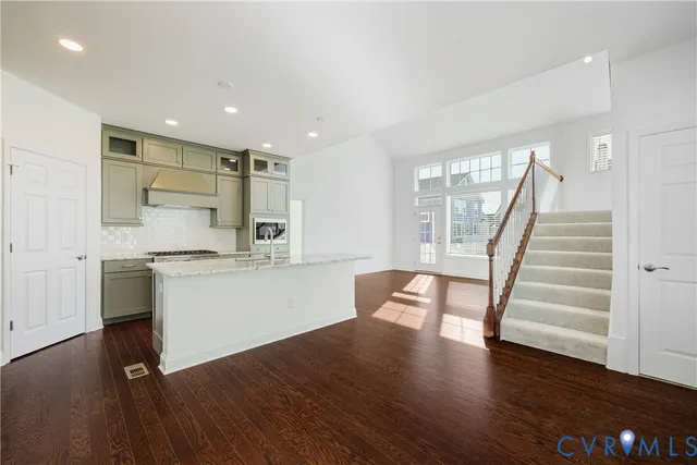 a kitchen with a wooden floor and outdoor view