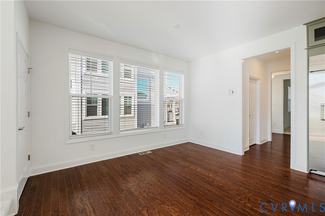 10689 Fern Basket Road Glen Allen, VA 23059 - Photo 10 of 50 a view of an empty room with wooden floor and a window