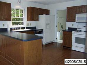 2267 Turnridge Court Fort Mill, SC 29708 - Photo 6 of 8 a kitchen with stainless steel appliances granite countertop a refrigerator a stove a sink and dishwasher with wooden floor