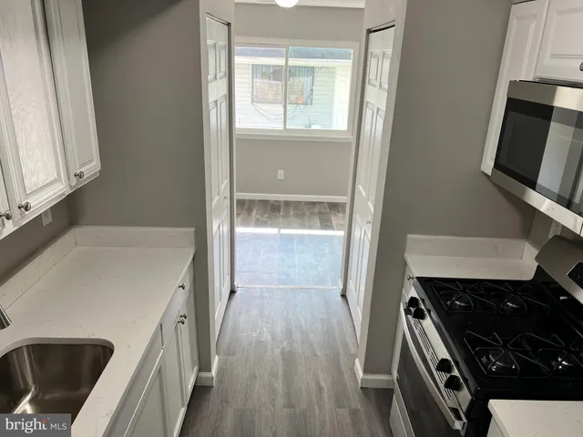 a kitchen with a sink stove and refrigerator