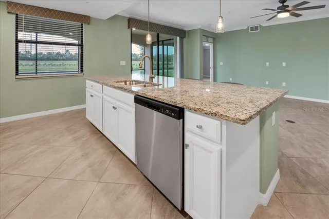 a bathroom with a granite countertop sink a mirror and a shower