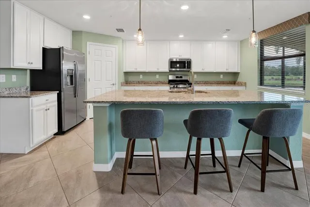 a spacious bathroom with a granite countertop sink mirror and shower