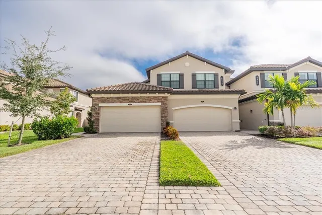 a front view of a house with a yard and garage