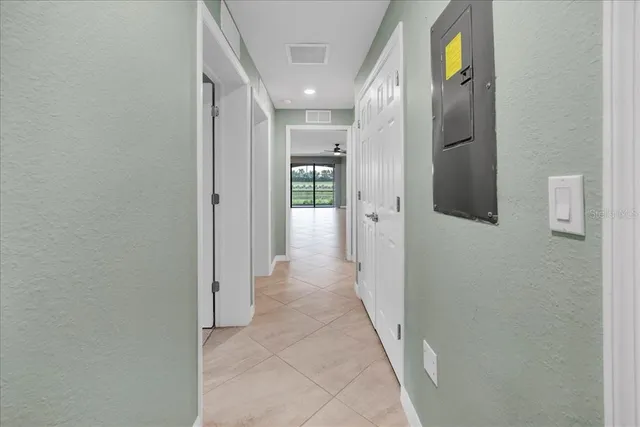 an aerial view of a house with a garden and lake view