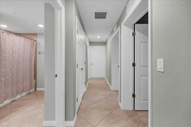 a front view of a house with garden and trees