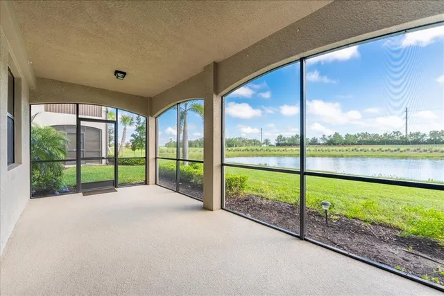 a view of a patio with a table and chairs under an umbrella