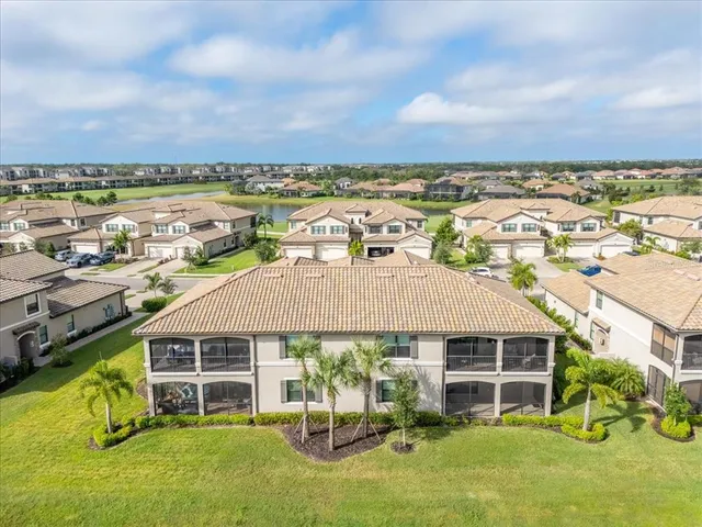 a swimming pool with outdoor seating and barbeque oven