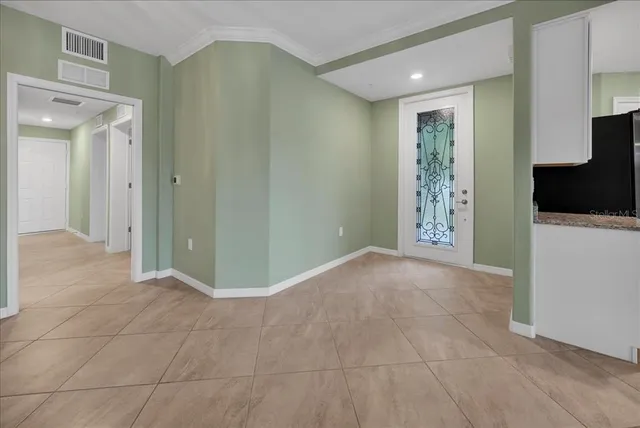 an empty room with windows and ceiling fan