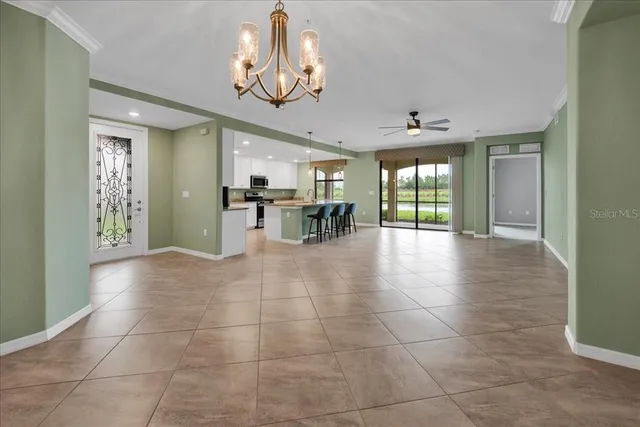 a view of a room with floor to ceiling window and chandelier