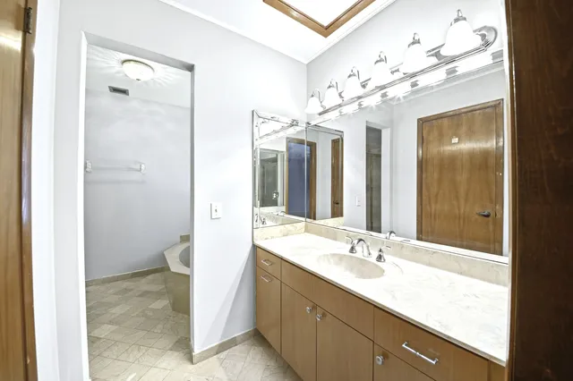 a bathroom with a granite countertop sink mirror and a shower