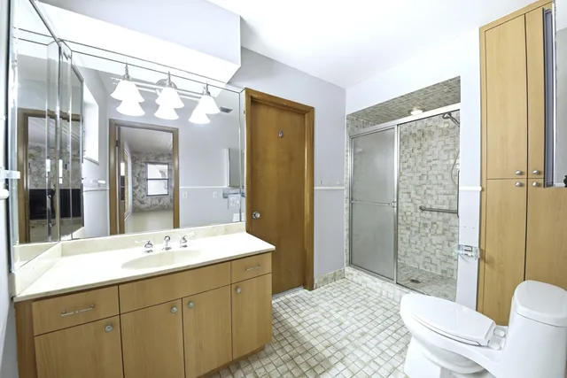 a bathroom with a sink a toilet and shower