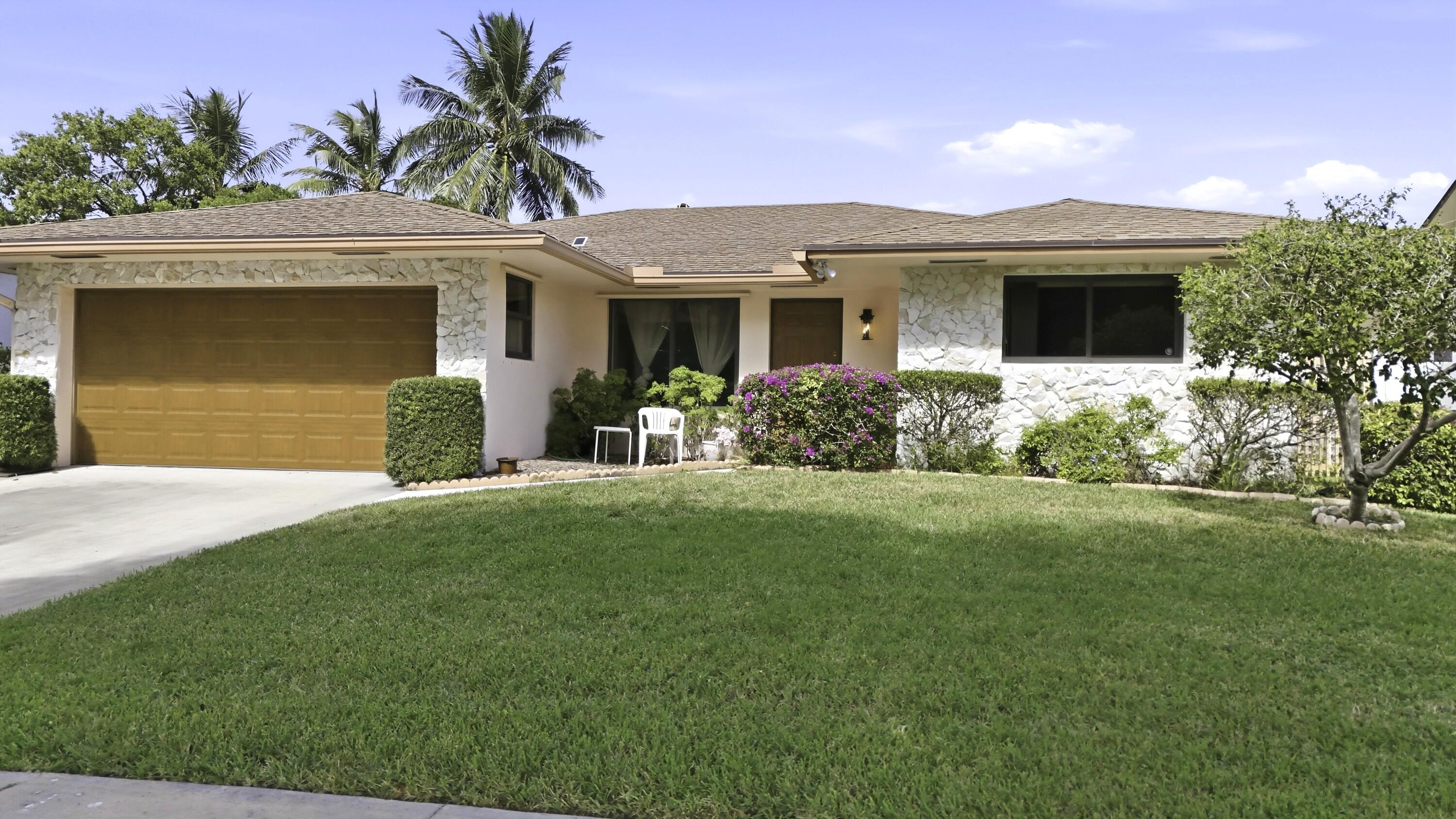 309 Southeast 4th Street Dania Beach, FL 33004 - Photo 2 of 23 a front view of a house with garden