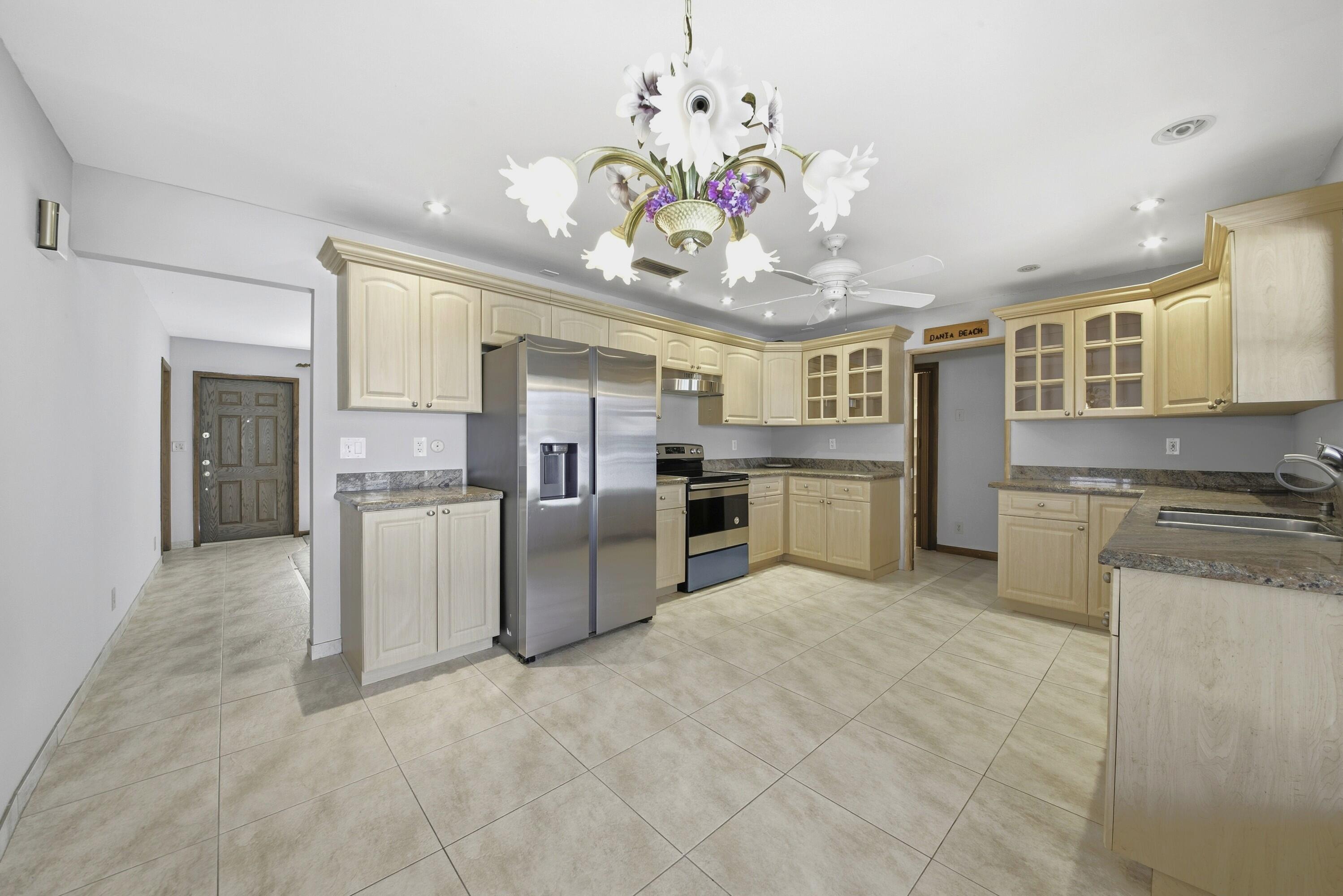 309 Southeast 4th Street Dania Beach, FL 33004 - Photo 5 of 23 a kitchen with refrigerator and cabinets