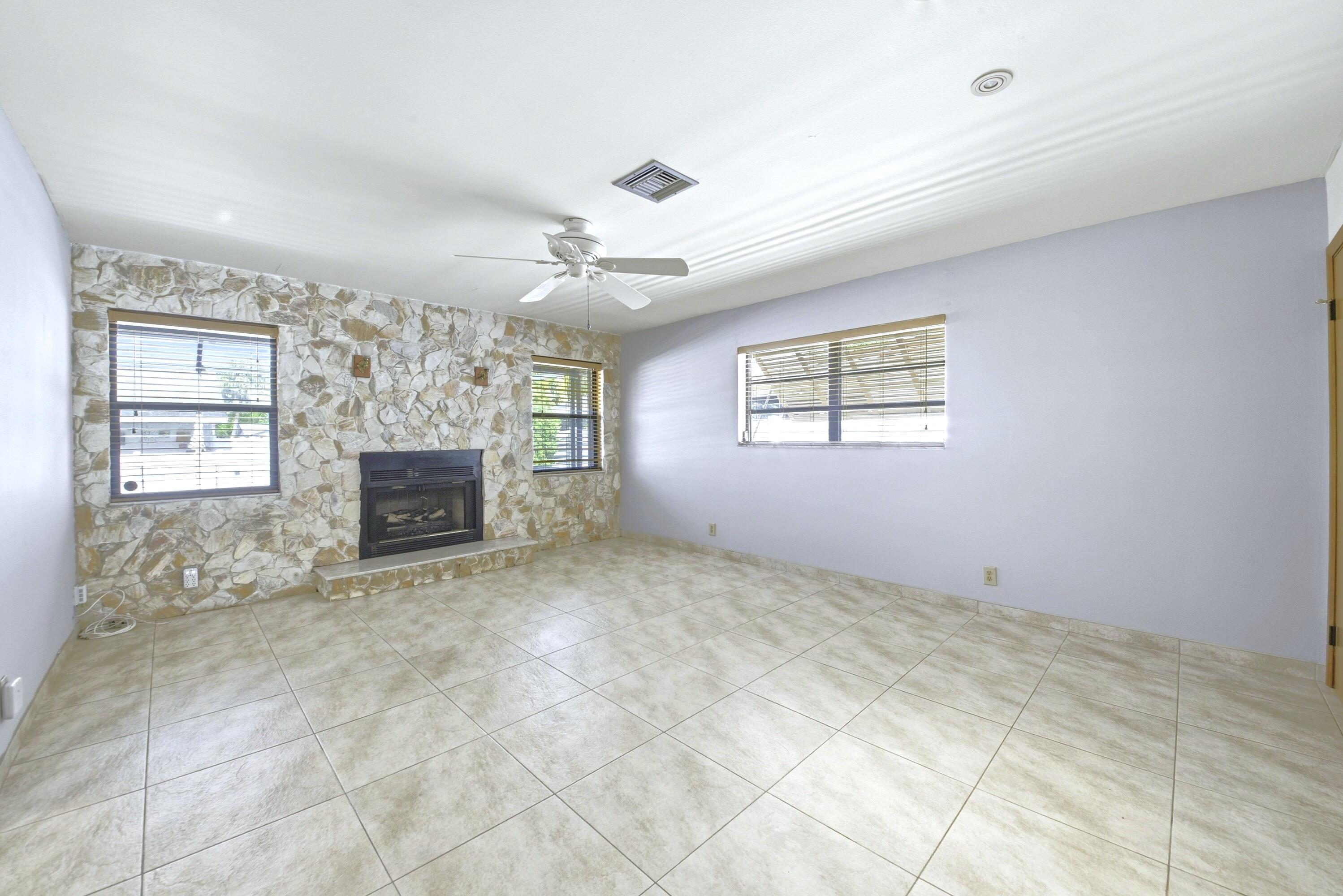 309 Southeast 4th Street Dania Beach, FL 33004 - Photo 8 of 23 a view of empty room with windows and fireplace