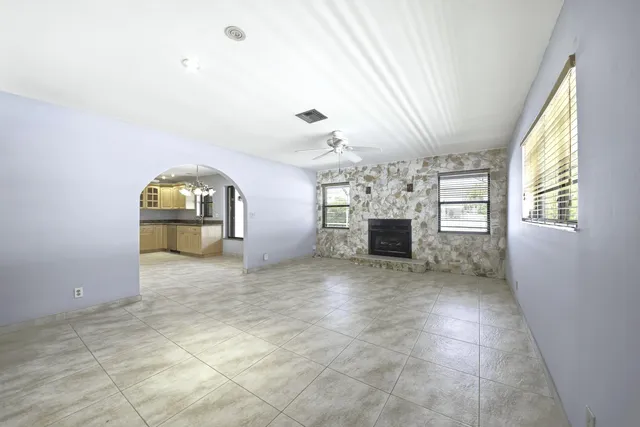 a view of a livingroom with a fireplace and window