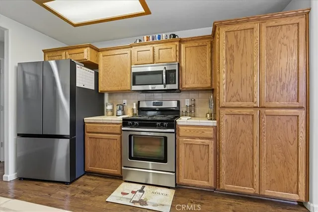 a kitchen with stainless steel appliances granite countertop a refrigerator stove and microwave