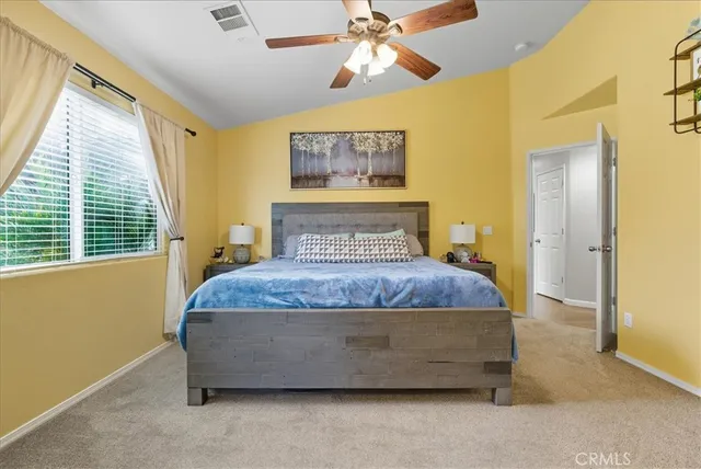 a bedroom with a bed and window