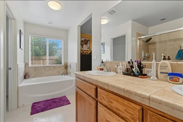 a bathroom with a tub sink and mirror