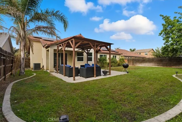 a view of a house with a big yard and large trees