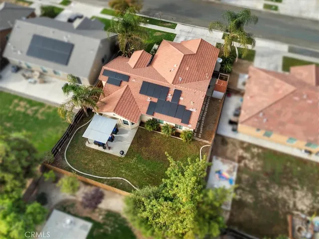 an aerial view of a house with garden space and street view