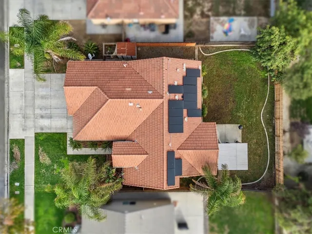 an aerial view of a house with a yard