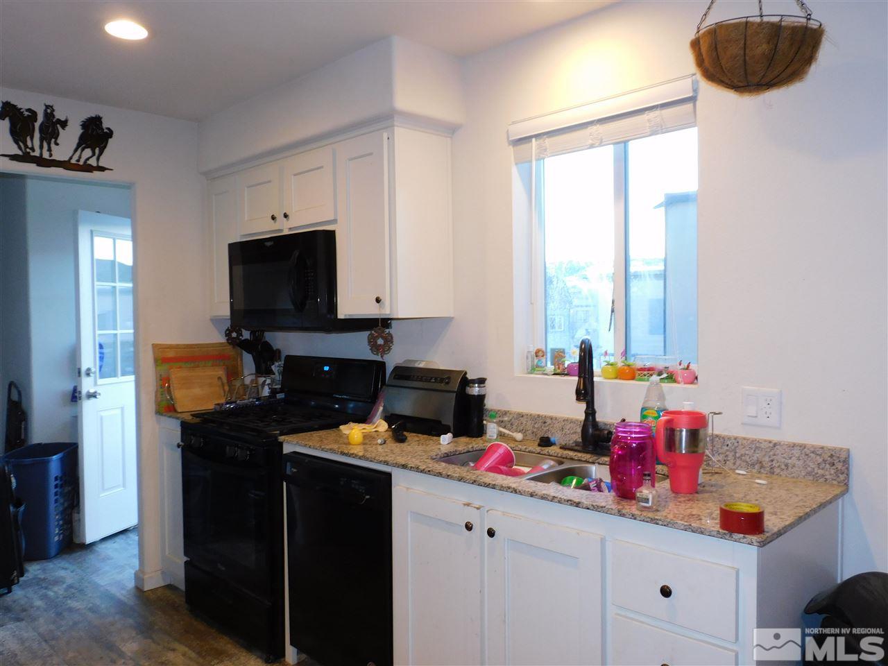 17875 Fantail Circle Reno, NV 89508 - Photo 2 of 15 a kitchen with a sink a stove and a wooden floor