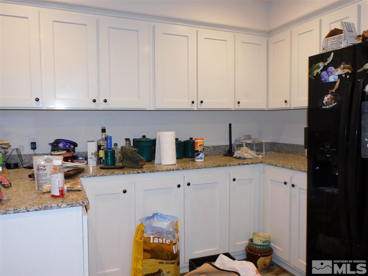 17875 Fantail Circle Reno, NV 89508 - Photo 4 of 15 a kitchen with stainless steel appliances granite countertop a sink a refrigerator and cabinets