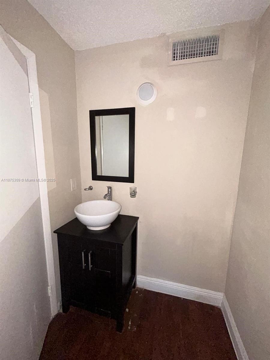 19741 Southwest 114th Avenue, Unit 361 Miami, FL 33157 - Photo 11 of 20 a bathroom with a sink a mirror and toilet